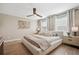 Serene main bedroom featuring a ceiling fan, natural light, and neutral decor at 1099 Thornbury Pl, Highlands Ranch, CO 80129