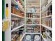 Organized walk-in pantry with shelving for ample food and supply storage at 1099 Thornbury Pl, Highlands Ranch, CO 80129