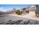 Serene suburban street featuring well-maintained homes with manicured lawns and mature trees on a sunny day at 1099 Thornbury Pl, Highlands Ranch, CO 80129