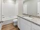 Bright bathroom featuring granite countertop, bathtub, and tiled shower at 770 Twining Ave, Brighton, CO 80601
