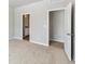 Bright bedroom featuring neutral carpet, and ensuite bath and closet access at 770 Twining Ave, Brighton, CO 80601