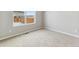 Bedroom with neutral walls, base trim and carpet, plus a large window at 770 Twining Ave, Brighton, CO 80601