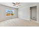 Bedroom features neutral carpeting and a large window overlooking the backyard at 770 Twining Ave, Brighton, CO 80601