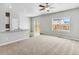 Open-concept living area with a sliding glass door, carpet, and an adjacent kitchen at 770 Twining Ave, Brighton, CO 80601