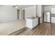 Open-concept design with laminate flooring that connects the living area to the stainless steel kitchen at 770 Twining Ave, Brighton, CO 80601