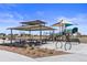 Community playground featuring a covered picnic area, play structure, and various recreational amenities for outdoor enjoyment at 770 Twining Ave, Brighton, CO 80601