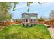 Spacious backyard with a well-maintained lawn, a fenced perimeter, and patio furniture at 4873 S Fultondale Way, Aurora, CO 80016