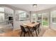 Open concept dining area with hardwood floors and access to a backyard patio at 4873 S Fultondale Way, Aurora, CO 80016