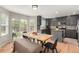 Bright dining area featuring hardwood floors, a large wooden table, and views of the backyard at 4873 S Fultondale Way, Aurora, CO 80016