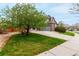Beautiful home with green lawn, mature tree, spacious driveway, and an attached two-car garage at 4873 S Fultondale Way, Aurora, CO 80016