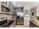 Contemporary kitchen featuring stainless steel appliances, gray cabinets, and granite countertops at 4873 S Fultondale Way, Aurora, CO 80016