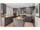 Stylish kitchen with gray cabinets, stainless steel appliances, granite countertops, and an island at 4873 S Fultondale Way, Aurora, CO 80016