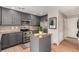 Well-lit kitchen with gray cabinets, stainless steel appliances, granite countertops, and hardwood floors at 4873 S Fultondale Way, Aurora, CO 80016