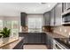 Modern kitchen with gray cabinets, granite countertops, stainless steel appliances and view of the backyard at 4873 S Fultondale Way, Aurora, CO 80016