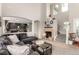 Neutral living room featuring high ceilings, a fireplace, and an arched entryway into the kitchen at 4873 S Fultondale Way, Aurora, CO 80016