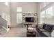 Bright living room features tall windows, neutral walls, and comfortable, contemporary furnishings at 4873 S Fultondale Way, Aurora, CO 80016