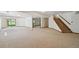 Expansive basement area with carpet flooring, natural light, and access to the outdoors at 1105 Oakhurst Dr, Broomfield, CO 80020