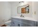 This is a bathroom featuring a modern vanity, stylish mirror, and toilet at 1105 Oakhurst Dr, Broomfield, CO 80020