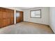 Spacious bedroom featuring neutral carpet flooring, closet space, and a window for natural light at 1105 Oakhurst Dr, Broomfield, CO 80020