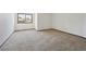 Empty bedroom with carpet flooring, a window for natural light, and neutral walls at 1105 Oakhurst Dr, Broomfield, CO 80020