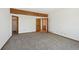 This is a spacious bedroom boasting neutral carpet, multiple doorways, and a decorative beam at 1105 Oakhurst Dr, Broomfield, CO 80020