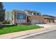 Well-maintained two-story brick home features a manicured lawn and a spacious driveway leading to an attached garage at 1105 Oakhurst Dr, Broomfield, CO 80020