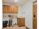 A utility room features ample cabinet space, sink, and tile floors at 1105 Oakhurst Dr, Broomfield, CO 80020