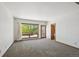 Bright living room featuring a large window with an outdoor view and access to an outside deck at 1105 Oakhurst Dr, Broomfield, CO 80020
