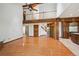 Spacious living area with hardwood floors, a balcony, and seamless access to the kitchen, ideal for Gathering living at 1105 Oakhurst Dr, Broomfield, CO 80020