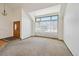 Bright living room with a large front window and neutral carpet at 1105 Oakhurst Dr, Broomfield, CO 80020