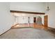 Bright living room with hardwood floors, a staircase, and a beamed ceiling, perfect for entertaining at 1105 Oakhurst Dr, Broomfield, CO 80020