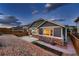 Exterior backyard view featuring stone and siding, patio, and partial fence at 25 N Irvington St, Aurora, CO 80018