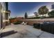 Backyard with a stone retaining wall, patio, lawn, and outdoor furniture with grills at 25 N Irvington St, Aurora, CO 80018