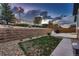 Backyard with a stone retaining wall, patio, lawn, and lush plantings at 25 N Irvington St, Aurora, CO 80018