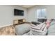 Basement living room featuring a comfortable sectional couch and a modern entertainment center at 25 N Irvington St, Aurora, CO 80018