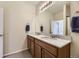 Neutral bathroom featuring a double sink vanity with marble countertop and wood cabinets at 25 N Irvington St, Aurora, CO 80018