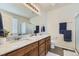 Bright bathroom featuring double sinks with a marble countertop and wood cabinets at 25 N Irvington St, Aurora, CO 80018
