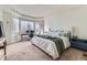 Main bedroom featuring large windows, a king bed, and neutral decor at 25 N Irvington St, Aurora, CO 80018