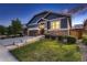 Charming home featuring stone accents, blue siding, a well-manicured lawn, and a two-car garage at 25 N Irvington St, Aurora, CO 80018