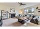 Comfortable living room with a fireplace, ceiling fan and bright natural light from a large window at 25 N Irvington St, Aurora, CO 80018
