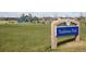 Traditions Park sign with large grassy field, playground, and gazebo in the background at 25 N Irvington St, Aurora, CO 80018