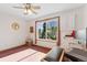 Bedroom featuring built-in cabinets, a large window, and sun-themed decor at 2251 Cliffrose Ln, Louisville, CO 80027