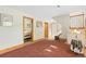 Hallway with tile and carpet flooring leads to carpeted bedroom and stairs at 2251 Cliffrose Ln, Louisville, CO 80027