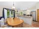 Open kitchen design with granite countertops, white cabinetry, and an adjacent dining area at 2251 Cliffrose Ln, Louisville, CO 80027