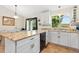 Bright kitchen featuring granite countertops, white cabinetry and a view of the backyard at 2251 Cliffrose Ln, Louisville, CO 80027