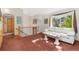Cozy living room with a comfortable white sofa and large window letting in natural light at 2251 Cliffrose Ln, Louisville, CO 80027
