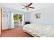 Bright main bedroom with ceiling fan, exterior deck access, and a decorative mirror at 2251 Cliffrose Ln, Louisville, CO 80027