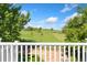 Scenic view from the deck overlooking a lush green field with grazing cows on a sunny day at 2251 Cliffrose Ln, Louisville, CO 80027