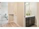 Bathroom with a vanity and mirror, hallway to the bathroom and bedroom, and a cabinet at 2144 Coyote Mint Dr, Monument, CO 80132