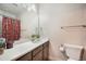Bathroom with a large mirror, floral shower curtain, and natural light, toilet paper roll at 2144 Coyote Mint Dr, Monument, CO 80132